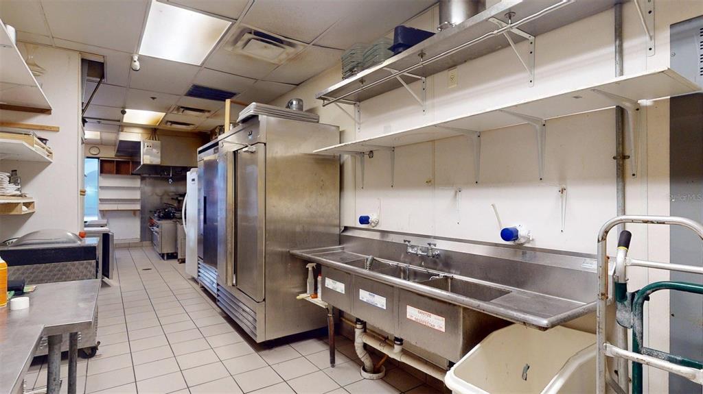 3983 Destination Drive, Unit 102 Osprey, FL 34229 - Photo 14 of 22 a kitchen with a sink appliances and cabinets