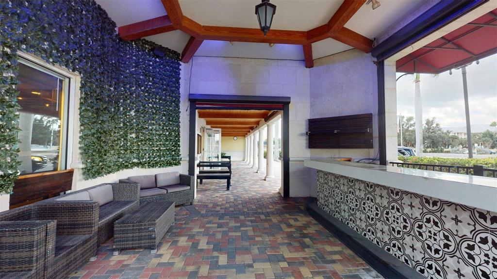 3983 Destination Drive, Unit 102 Osprey, FL 34229 - Photo 2 of 22 a lobby with furniture and outdoor space