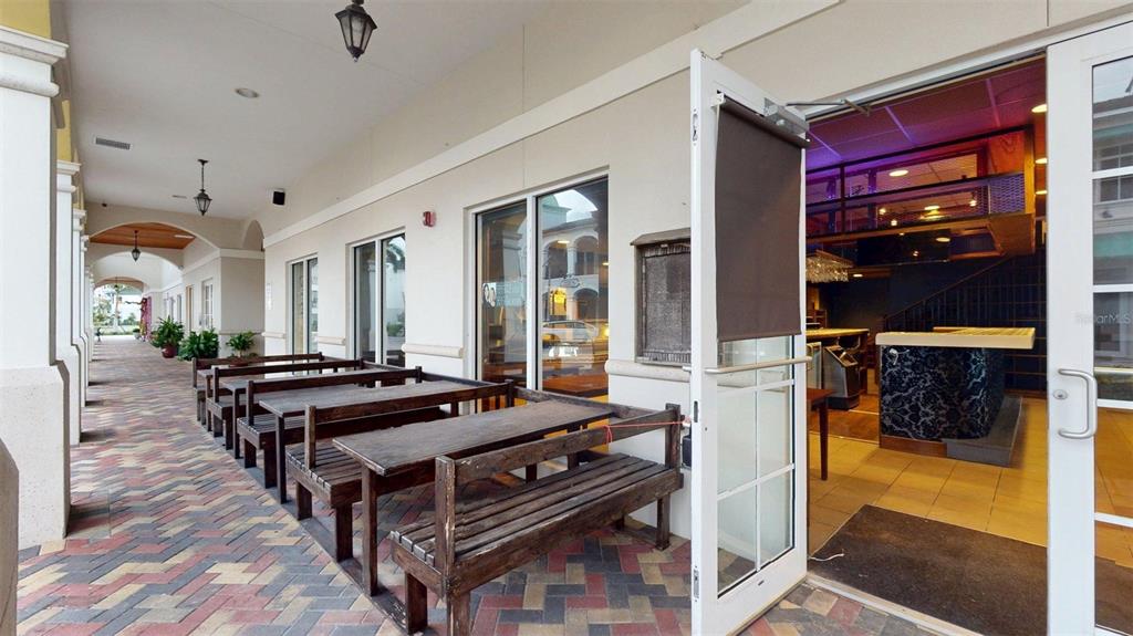 3983 Destination Drive, Unit 102 Osprey, FL 34229 - Photo 10 of 22 a living room with furniture flat screen tv and a fireplace