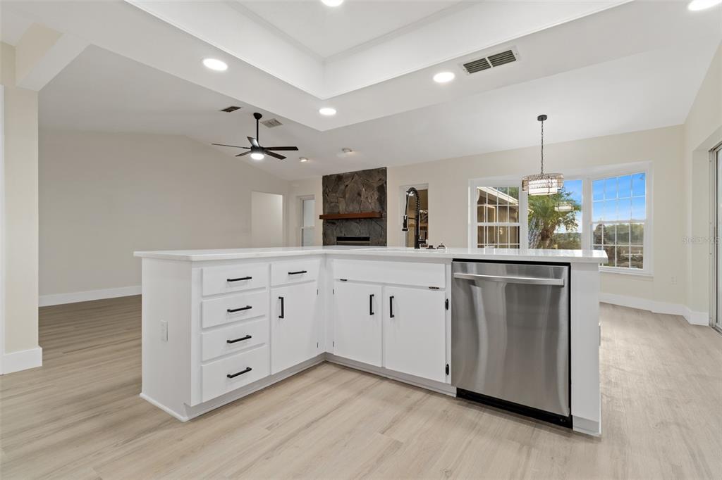3016 Abeline Road Spring Hill, FL 34608 - Photo 23 of 52 a kitchen with granite countertop white cabinets and white appliances