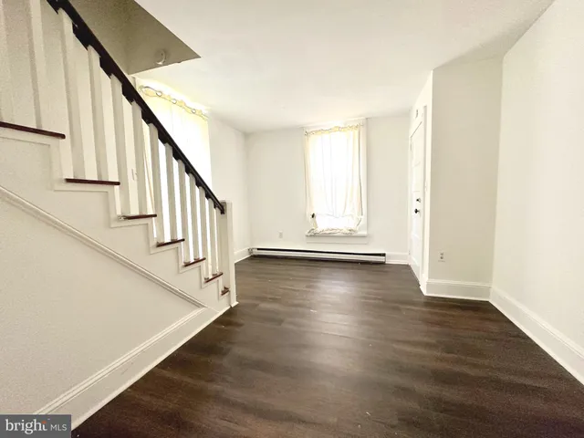 a view of an entryway with wooden floor