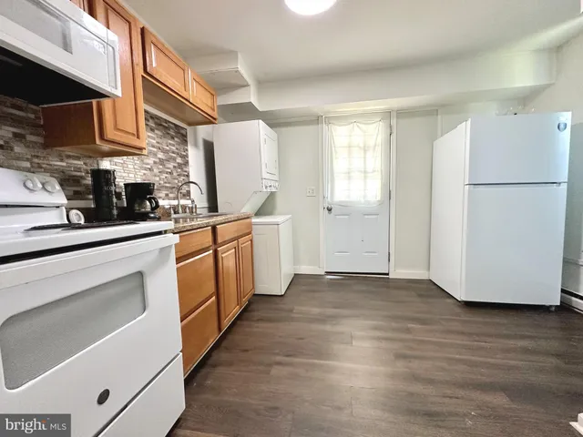 a kitchen with stainless steel appliances a refrigerator sink and cabinets