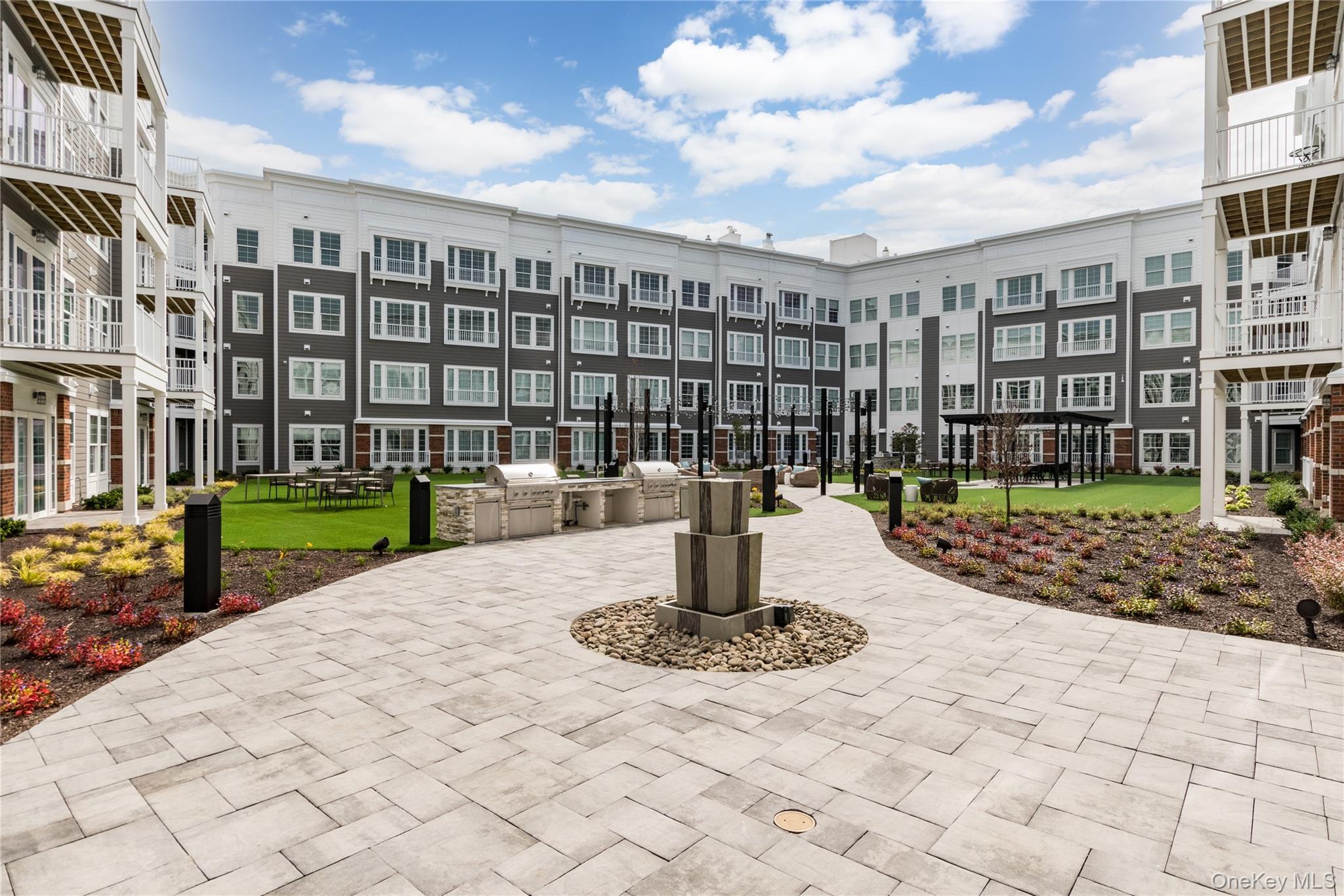 75 East Hoffman Avenue, Unit 3012 Lindenhurst, NY 11757 - Photo 2 of 8 a view of a building with a yard