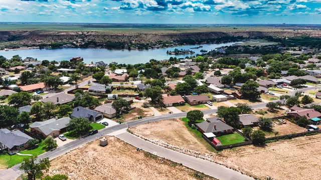 an aerial view of a houses with ocean view