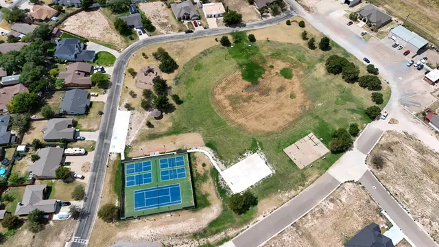 an aerial view of a house with a yard and garden