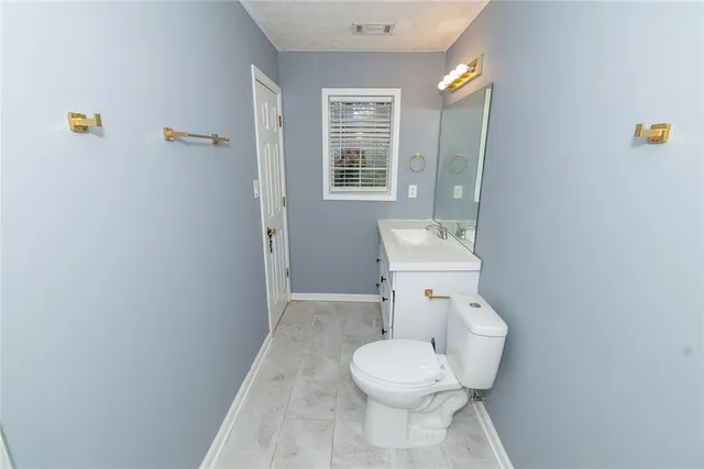 a white toilet sitting next to a bathroom sink