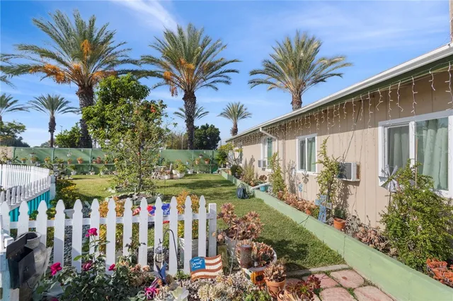 a group of people sitting in front of a house
