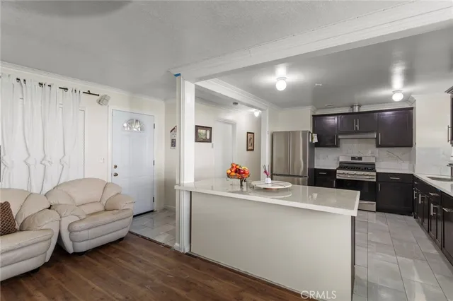 a living room with furniture and a kitchen