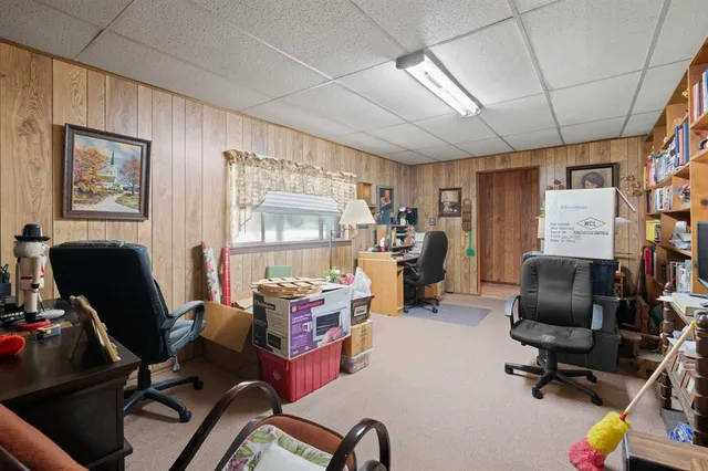 a view of a workspace with furniture and a window