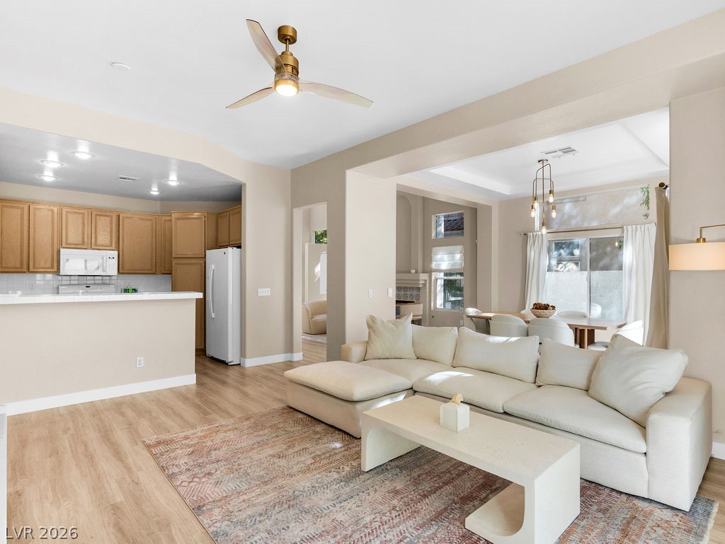 9201 Eagle Ridge Drive Las Vegas, NV 89134 - Photo 17 of 35 Living area featuring light wood finished floors and a ceiling fan