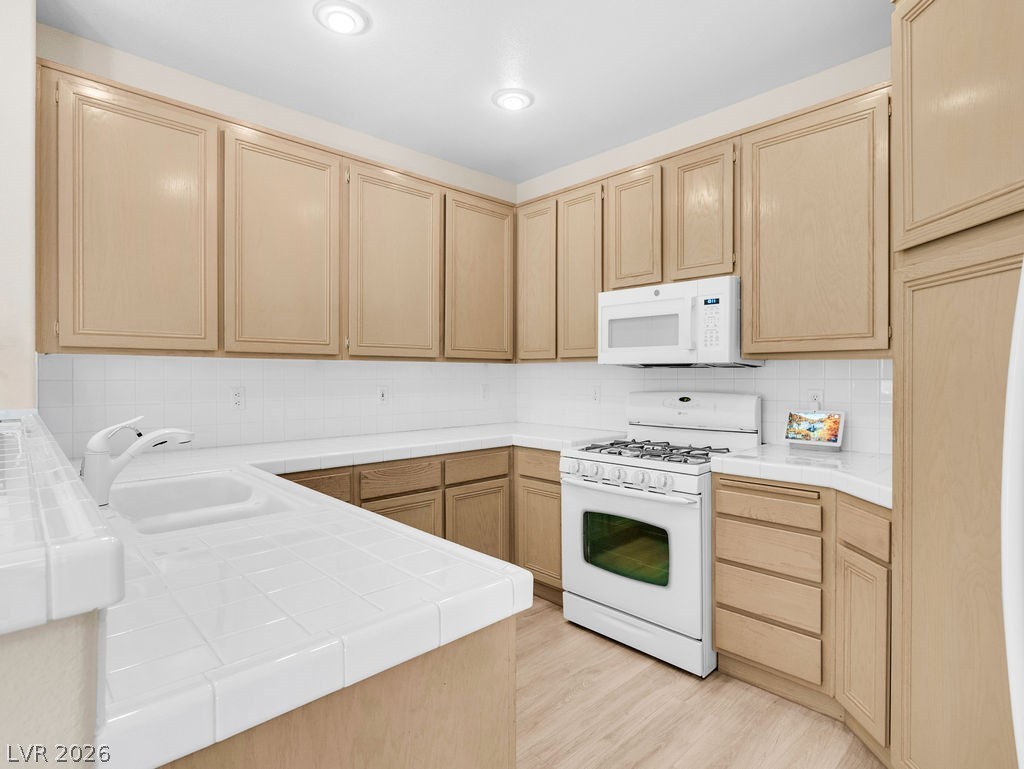 9201 Eagle Ridge Drive Las Vegas, NV 89134 - Photo 19 of 35 Spacious kitchen with breakfast bar and ample cabinetry.