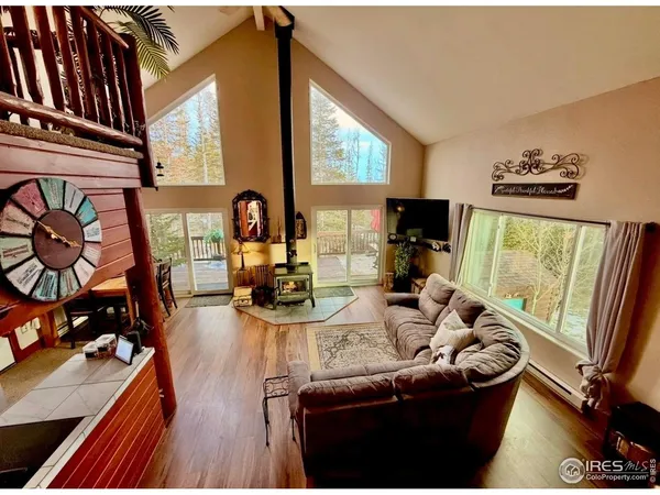 a view of a livingroom with furniture and a flat screen tv
