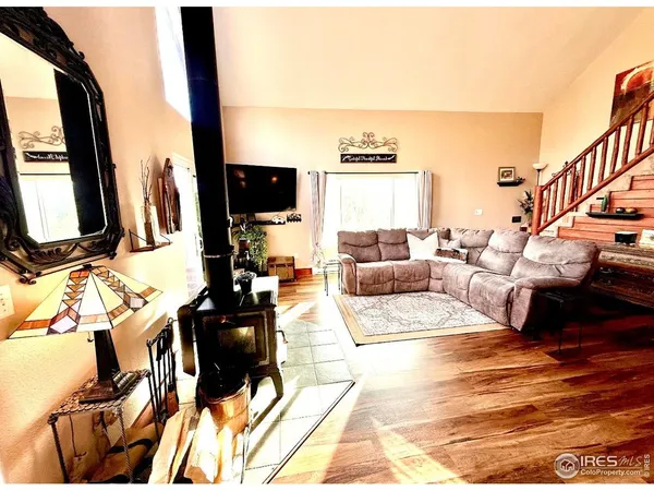 a view of a livingroom with workspace and a window