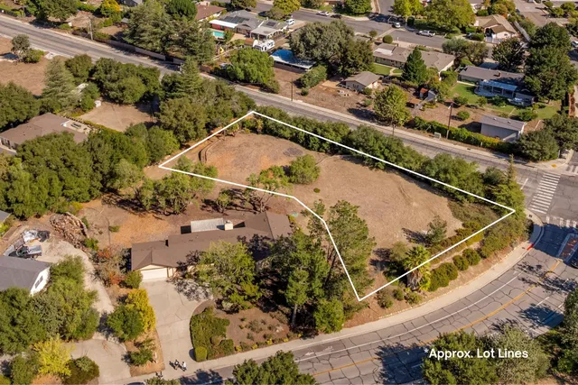 an aerial view of a residential houses with outdoor space