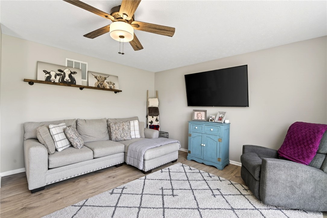39 Holly Court Springboro, OH 45066 - Photo 15 of 42 This inviting living area features warm flooring and a prominent ceiling fan for optimal comfort.