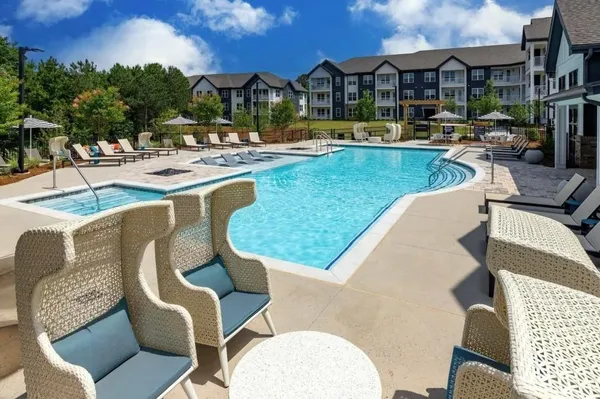 a view of a swimming pool with outdoor seating