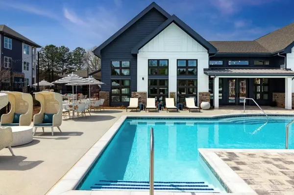 a view of a swimming pool with outdoor seating