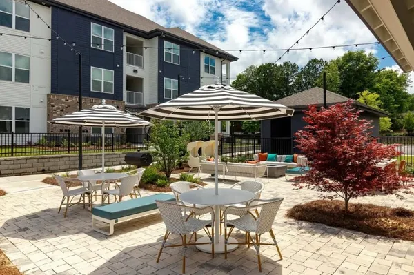 a view of a cafe with a table and chairs under an umbrella