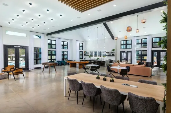 a dinning room with many windows and couches