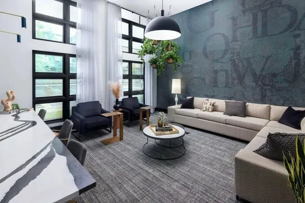 a living room with furniture and a potted plant