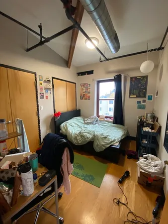 a bedroom that has a bed and a table in it