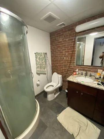 a bedroom with a bed and a chair