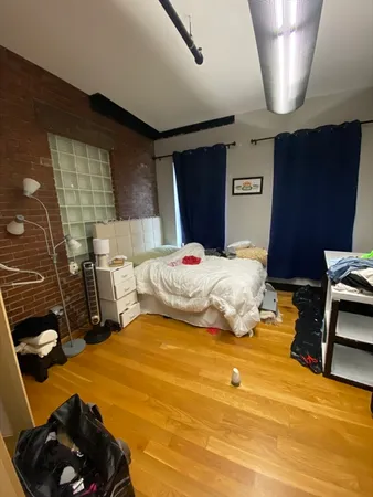 a bedroom with furniture and a flat screen tv