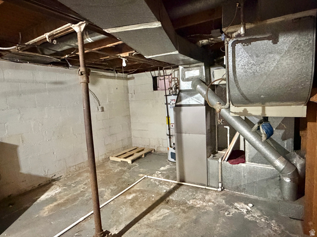 196 North 5th West Price, UT 84501 - Photo 16 of 27 Utility room featuring a water heater, furnace, exposed ductwork, exposed ceiling joists, and concrete block walls