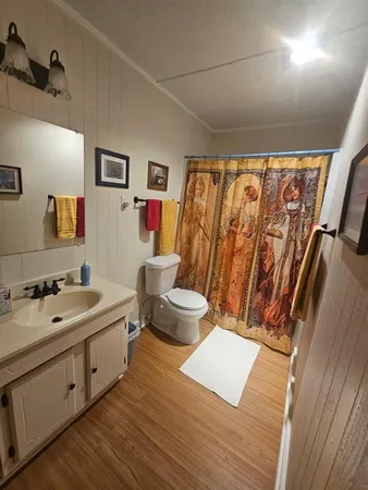 a living room with a couch wooden floor and a window