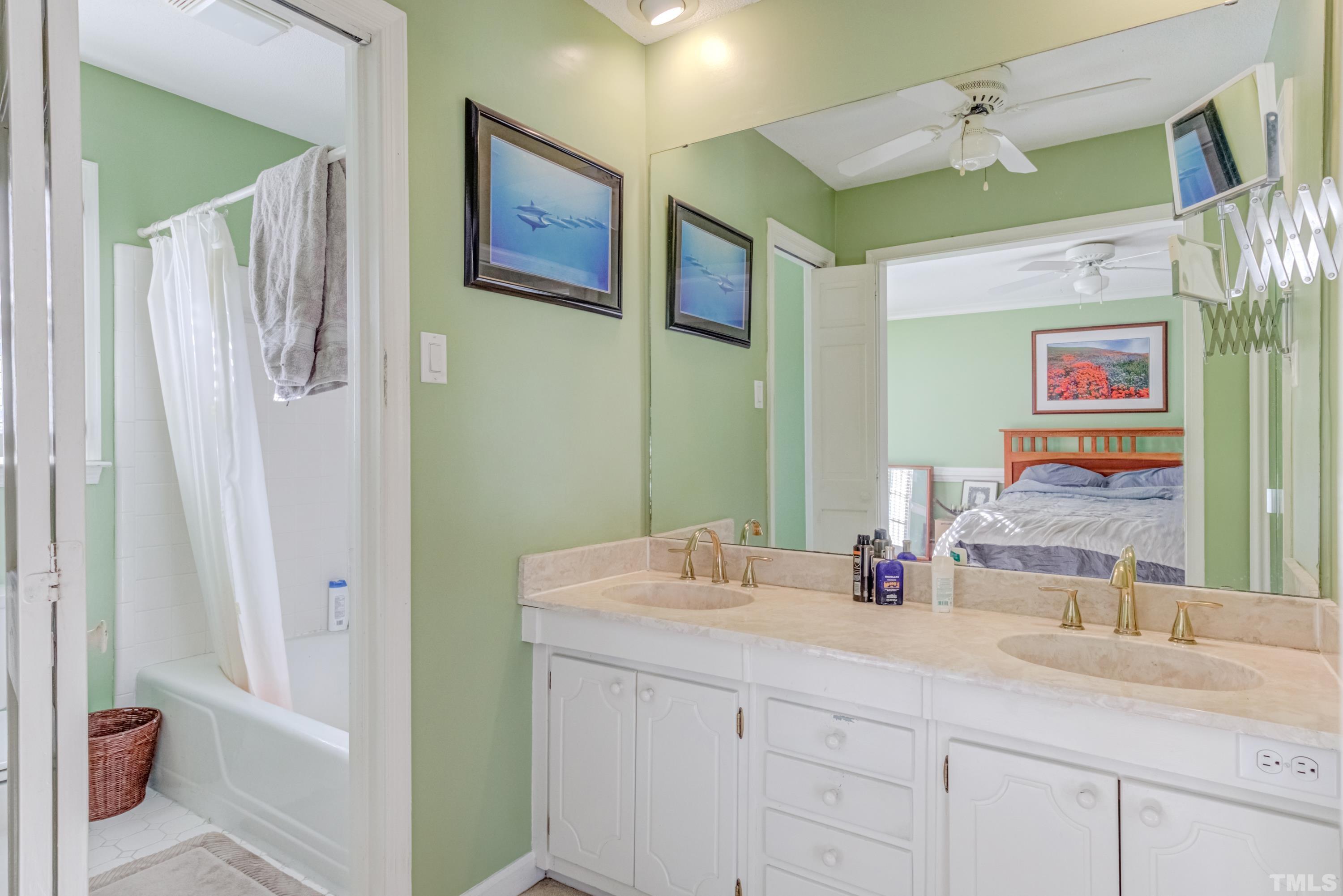 1508 Medfield Road Raleigh, NC 27607 - Photo 7 of 19 a bathroom with a double vanity sink and a mirror