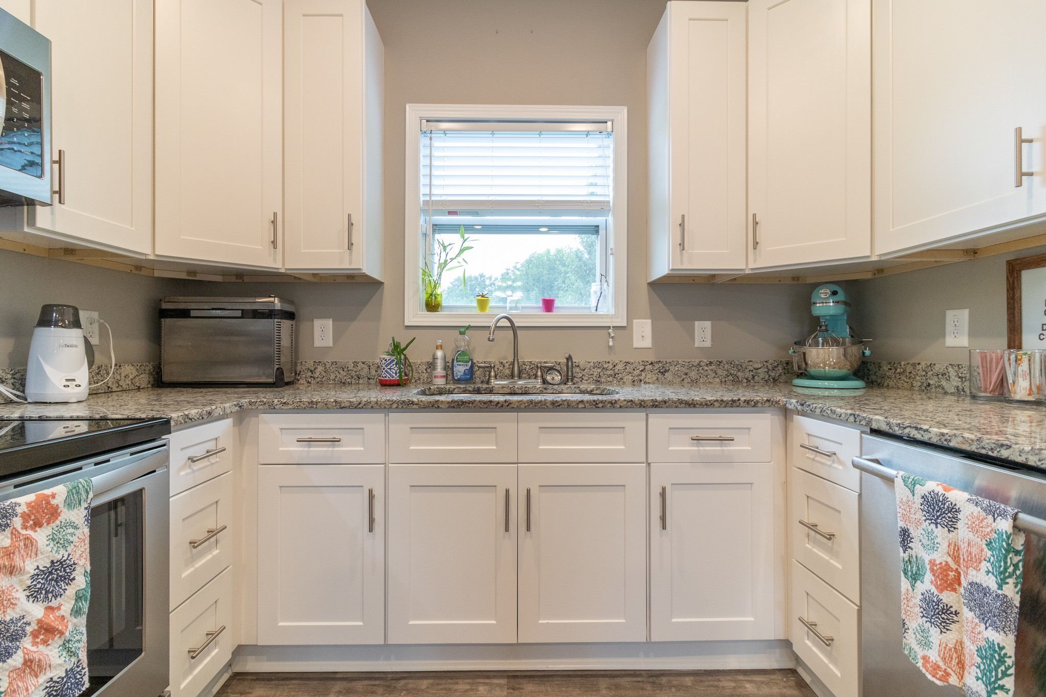 167 Fieldstone Lane Springfield, TN 37172 - Photo 10 of 36 a kitchen with granite countertop white cabinets and white appliances