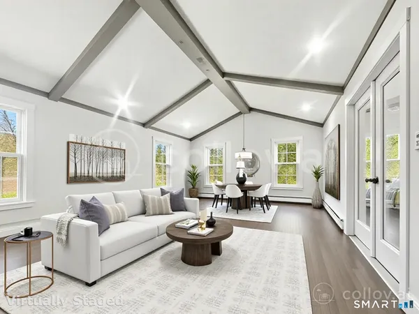 a living room with furniture and a potted plant