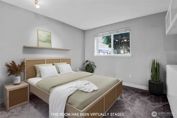 a bedroom with a bed and a painting on the wall