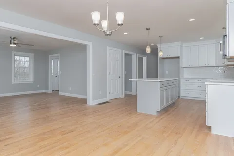 a view of a kitchen with an empty room and kitchen view