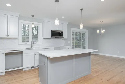 a kitchen with a sink stove and microwave