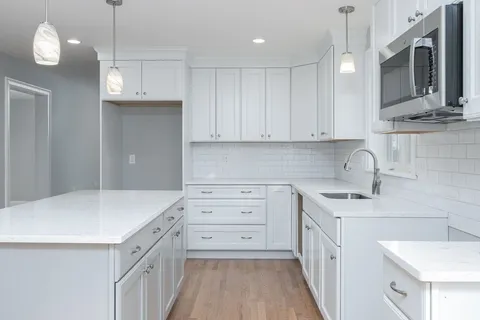 a kitchen with a sink stove and cabinets