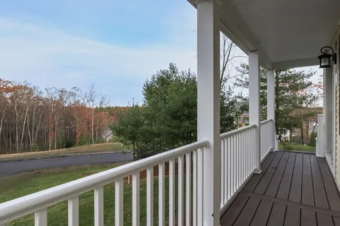 a view of a balcony with wooden floor