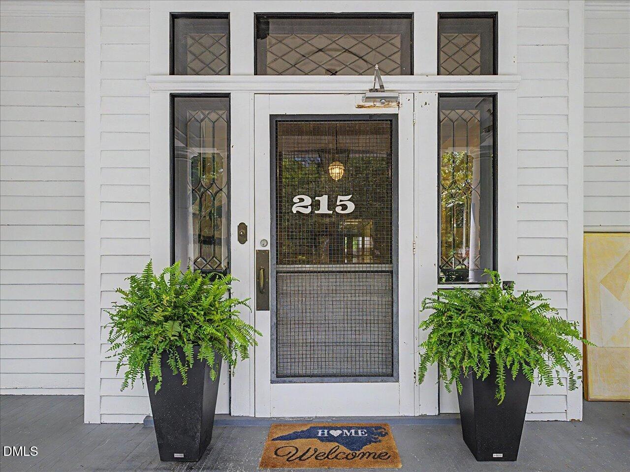215 Hillcrest Road Raleigh, NC 27605 - Photo 13 of 97 a potted plant in front of a house