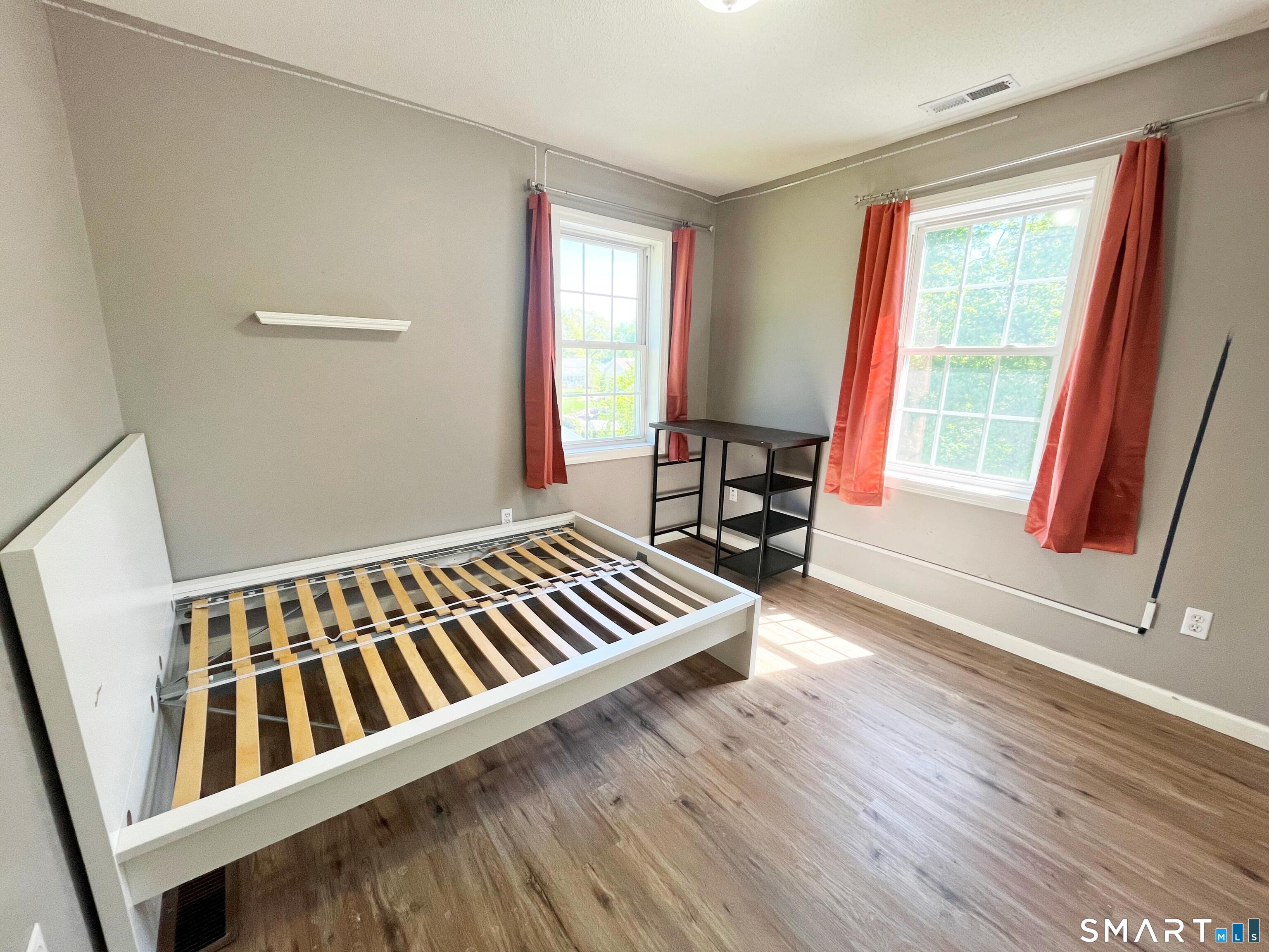 52 Monce Road Burlington, CT 06013 - Photo 13 of 26 a view of an empty room with wooden floor and chair