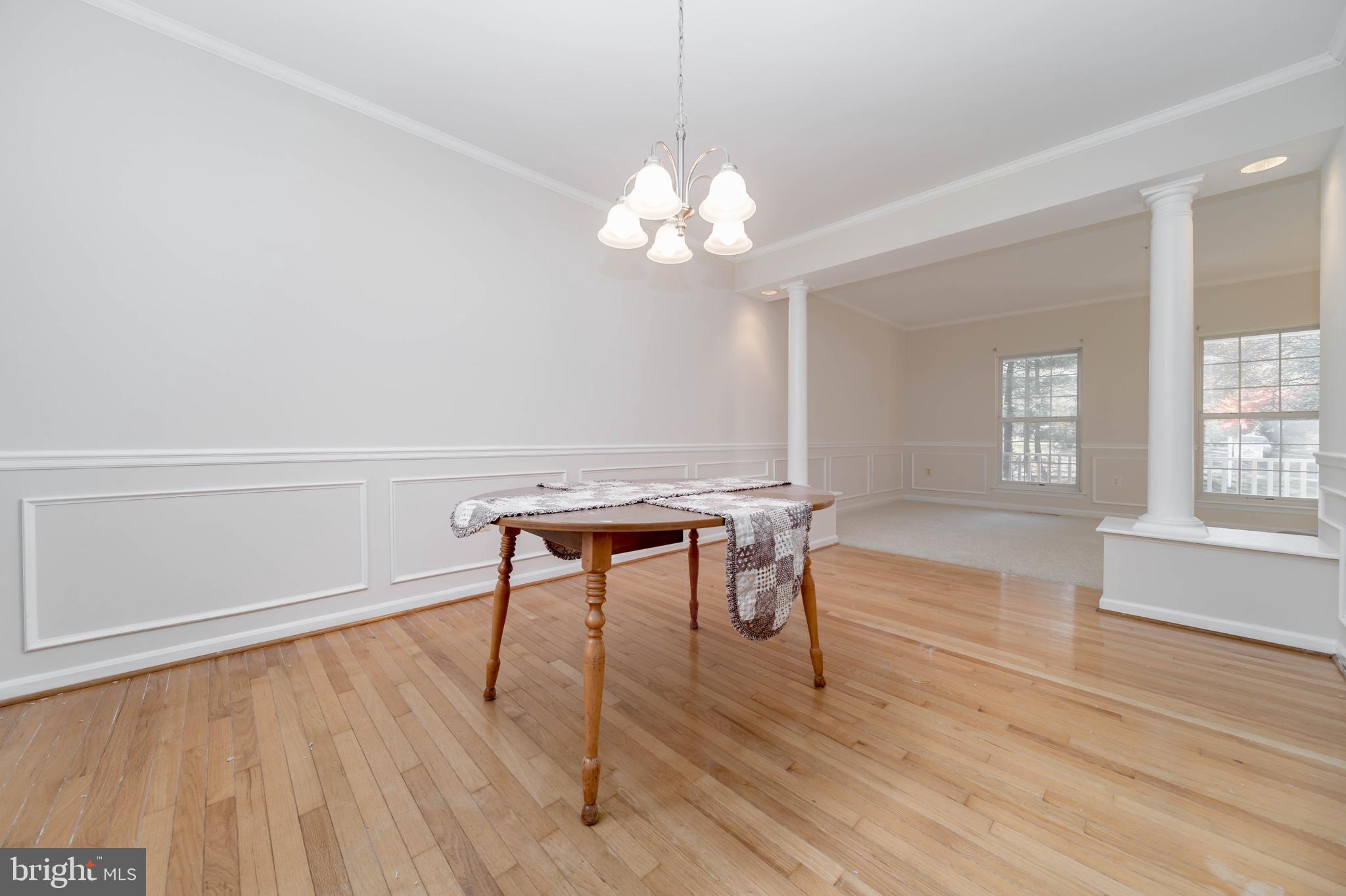 620 Small Reward Road Huntingtown, MD 20639 - Photo 5 of 33 a view of a livingroom with a furniture wooden floor and a chandelier