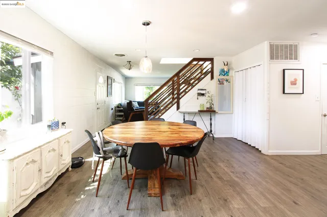 a dining room with furniture and wooden floor