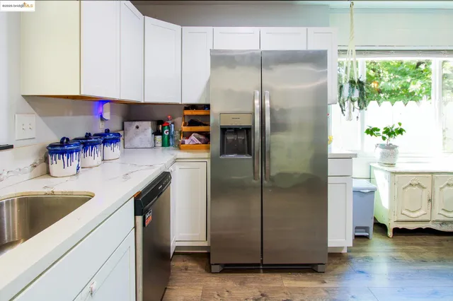 a kitchen with a refrigerator and a sink