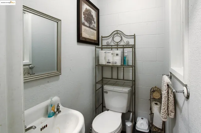 a white toilet sitting next to a bathroom sink