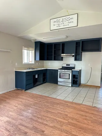 a kitchen with stainless steel appliances a stove and cabinets
