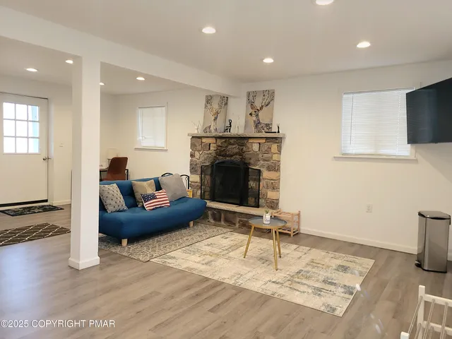 a living room with furniture a fireplace and a flat screen tv