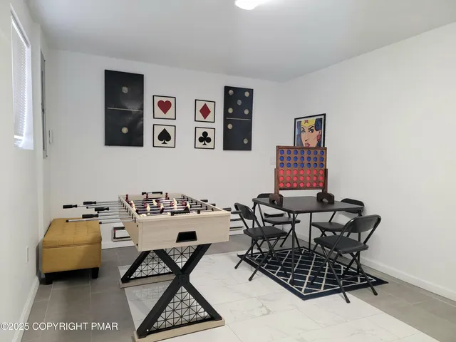 a work room with furniture and air hockey table