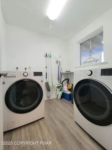 a utility room with sink dryer and washer