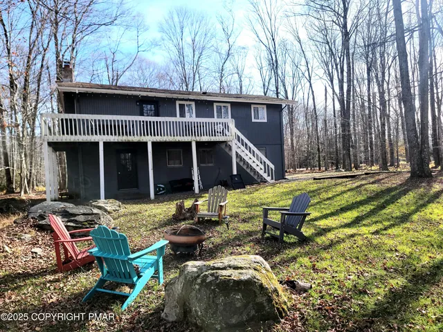 a view of a house with backyard and sitting area
