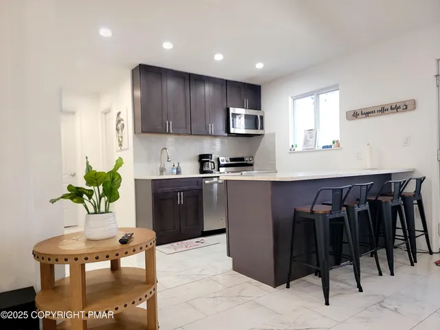 a kitchen with cabinets and chairs in it