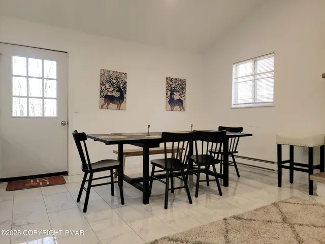 a view of a dining room with furniture and a window